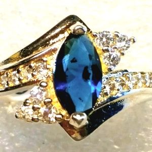 Blue sapphire, marquis cut center stone.